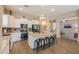 Kitchen with island and bar seating, stainless appliances, and an open layout to the living area at 19969 N Santa Cruz Dr, Maricopa, AZ 85138