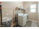 Bright laundry room featuring a washer, dryer, storage shelves, and a decorative 'Wash, Dry, Fold' sign at 19969 N Santa Cruz Dr, Maricopa, AZ 85138