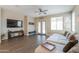 Bright living room featuring tile floors, neutral paint, ceiling fan, and access to the exterior at 19969 N Santa Cruz Dr, Maricopa, AZ 85138