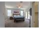 Spacious primary bedroom with a ceiling fan, and access to the backyard through glass doors at 19969 N Santa Cruz Dr, Maricopa, AZ 85138