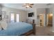 Tranquil main bedroom with a king bed, a ceiling fan, and a view towards the bathroom at 19969 N Santa Cruz Dr, Maricopa, AZ 85138
