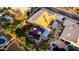Aerial view of a backyard with a pool, jacuzzi, covered patio, outdoor seating, lush landscaping, and mature trees at 2058 E Marlene Dr, Gilbert, AZ 85296