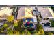Aerial view of a backyard with a pool, jacuzzi, covered patio, outdoor seating, lush landscaping, and mature trees at 2058 E Marlene Dr, Gilbert, AZ 85296