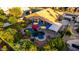 Aerial view of a backyard with a pool, jacuzzi, outdoor seating, lush landscaping, and mature trees at 2058 E Marlene Dr, Gilbert, AZ 85296