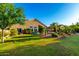 A lush backyard with a well-maintained lawn, colorful landscaping, and a sparkling pool, ideal for outdoor entertaining at 2058 E Marlene Dr, Gilbert, AZ 85296