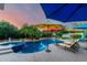Beautiful backyard with a sparkling pool, spa, comfortable lounge seating, and tropical landscaping for serene outdoor living at 2058 E Marlene Dr, Gilbert, AZ 85296