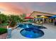Picturesque backyard featuring a pool, spa, lounge chairs, and vibrant landscaping, ideal for relaxation and recreation at 2058 E Marlene Dr, Gilbert, AZ 85296