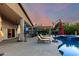 Gorgeous backyard oasis with a pool, spa, lounge chairs, covered patio, and lush landscaping for luxurious outdoor living at 2058 E Marlene Dr, Gilbert, AZ 85296