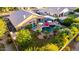 Aerial view of a backyard with a pool, jacuzzi, outdoor seating, lush landscaping, and mature trees at 2058 E Marlene Dr, Gilbert, AZ 85296