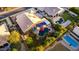 Aerial view of a backyard with a pool, jacuzzi, covered patio, outdoor seating, lush landscaping, and mature trees at 2058 E Marlene Dr, Gilbert, AZ 85296