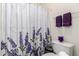 Bathroom with a floral shower curtain, white toilet, and decorative towels at 2058 E Marlene Dr, Gilbert, AZ 85296