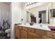 Bathroom featuring a double sink vanity with wooden cabinets and a large mirror at 2058 E Marlene Dr, Gilbert, AZ 85296