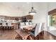 Elegant dining room with natural light, a stylish chandelier, and seamless access to the kitchen at 2058 E Marlene Dr, Gilbert, AZ 85296