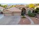 Inviting single-story home with a three-car garage and manicured front yard with desert landscaping at 2058 E Marlene Dr, Gilbert, AZ 85296