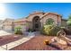 Single-story home features arched entry, three-car garage, terracotta roof, and low-maintenance desert landscaping at 2058 E Marlene Dr, Gilbert, AZ 85296