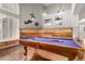 Game room with billiards table, wood flooring, and natural light from an arched window at 2058 E Marlene Dr, Gilbert, AZ 85296