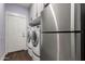 Functional laundry room with a modern washer and dryer, a refrigerator, and storage cabinets at 2058 E Marlene Dr, Gilbert, AZ 85296