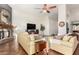 Comfortable living room with stone fireplace, TV, and plush seating, ideal for relaxation and entertainment at 2058 E Marlene Dr, Gilbert, AZ 85296