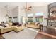 Bright, open-concept living room features a stone fireplace, high ceilings, large windows, and comfortable seating at 2058 E Marlene Dr, Gilbert, AZ 85296