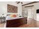 Spacious main bedroom with wooden floors, beamed ceilings, ensuite bath and access to private bath at 2058 E Marlene Dr, Gilbert, AZ 85296