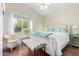 Bright bedroom with a white bed, decorative pillows, wicker chair, and a window providing natural light at 2058 E Marlene Dr, Gilbert, AZ 85296