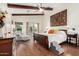 Main bedroom with exposed beam ceiling, wood floors and access to outdoor living space at 2058 E Marlene Dr, Gilbert, AZ 85296