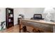 Well-lit office featuring a wooden desk, modern chair, and a bookshelf at 2058 E Marlene Dr, Gilbert, AZ 85296