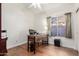 Home office with a wooden desk, chair, and a window providing natural light at 2058 E Marlene Dr, Gilbert, AZ 85296