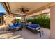 Spacious covered patio with comfortable seating, ceiling fans, and a built-in bar, ideal for outdoor entertainment at 2058 E Marlene Dr, Gilbert, AZ 85296