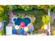 Aerial view of a backyard with a pool, jacuzzi, colorful umbrellas, and lush landscaping at 2058 E Marlene Dr, Gilbert, AZ 85296