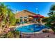 Backyard view of a sparkling pool and patio area, surrounded by lush landscaping, providing a perfect oasis for relaxation at 2058 E Marlene Dr, Gilbert, AZ 85296
