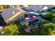 Aerial view of a backyard with a private pool, spa, colorful umbrellas and lush landscaping at 2058 E Marlene Dr, Gilbert, AZ 85296