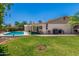 Expansive backyard features a lush green lawn, covered patio, and sparkling pool, ideal for outdoor living at 2312 W Temple St, Chandler, AZ 85224
