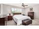 Bright bedroom with a ceiling fan, neutral carpet, and a large window with views at 2312 W Temple St, Chandler, AZ 85224