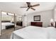 This bedroom features neutral walls, a ceiling fan, and closet with mirrored doors at 2312 W Temple St, Chandler, AZ 85224