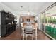 Dining area with modern lighting, sliding glass doors, and views to the kitchen at 2312 W Temple St, Chandler, AZ 85224