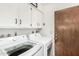 Well-equipped laundry room features a washer, dryer, and overhead cabinets at 2312 W Temple St, Chandler, AZ 85224