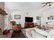 Inviting living room showcasing a brick fireplace, neutral sofa, and a ceiling fan at 2312 W Temple St, Chandler, AZ 85224