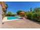Inviting backyard oasis with a refreshing pool, mature landscaping and a spacious brick patio for outdoor enjoyment at 2312 W Temple St, Chandler, AZ 85224