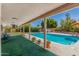 Beautiful backyard pool area with lush landscaping and a covered patio at 2312 W Temple St, Chandler, AZ 85224