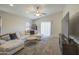 Bright living room with a vaulted ceiling, a large sofa, and recessed lighting at 24035 W La Salle St, Buckeye, AZ 85326
