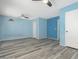 Bedroom with luxury vinyl flooring, ceiling fan, and light blue walls at 2437 E North Ln, Phoenix, AZ 85028