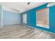 Bedroom with luxury vinyl flooring, ceiling fan, and blue walls at 2437 E North Ln, Phoenix, AZ 85028