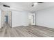 Spacious bedroom with luxury vinyl flooring, a ceiling fan, and a walk-in closet at 2437 E North Ln, Phoenix, AZ 85028