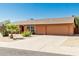 Single story home with well-kept yard, desert landscaping, and a two car garage at 2437 E North Ln, Phoenix, AZ 85028