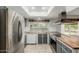 Bright kitchen with stainless steel appliances and a view of the backyard pool at 2437 E North Ln, Phoenix, AZ 85028