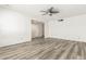 Open living room with updated gray flooring and white walls, ready for personalization at 2437 E North Ln, Phoenix, AZ 85028