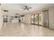 Open living room with light tile flooring and French doors that lead to the backyard pool at 2437 E North Ln, Phoenix, AZ 85028