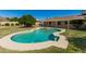 Private backyard oasis showcasing a kidney-shaped pool with home exterior and yard at 2437 E North Ln, Phoenix, AZ 85028