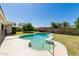 Sparkling kidney-shaped pool surrounded by lush greenery in a private backyard at 2437 E North Ln, Phoenix, AZ 85028